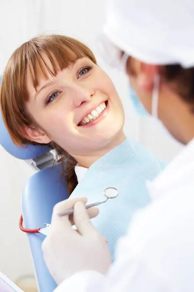 woman smiling in the dental chair during her appointment at Hymas Family Dental