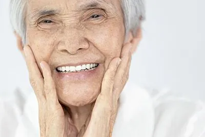 woman smiling after dental implants restored her smile