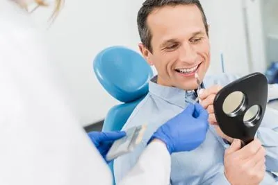 man choosing the color of his dental veneers at Hymas Family Dental in Spokane Valley, WA