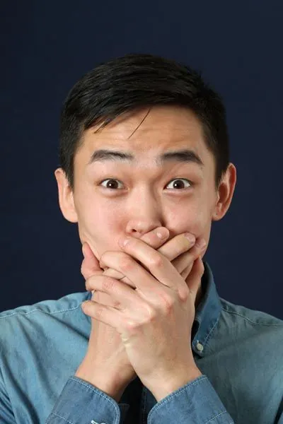 man holding his mouth from tooth pain