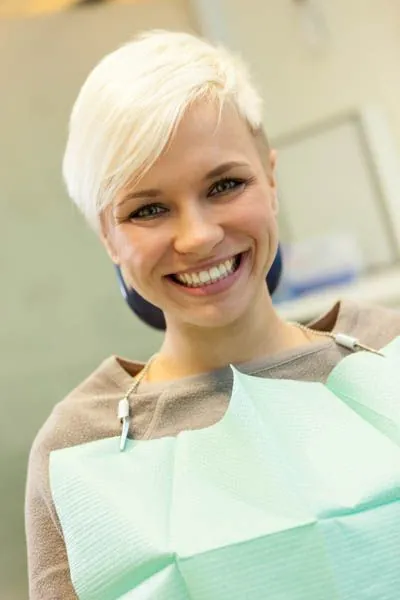 patient showing off her smile after getting periodontal treatment at Hymas Family Dental