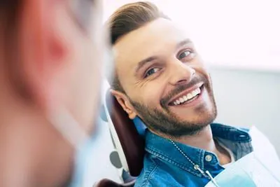 man smiling at the dentist during his dental appointment