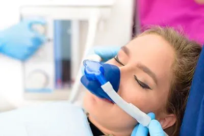 patient asleep for her dental procedure thanks to sedation services