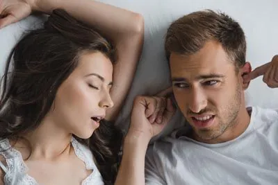 woman keeping her husband up at night due to sleep apnea