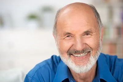 man with dentures smiling