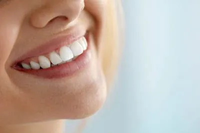 woman smiling after getting her teeth whitened at Hymas Family Dental