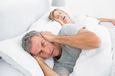 man awake at night due to his wife's sleep apnea
