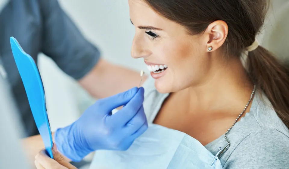 woman choosing which color dental veneer she would like during her visit to Hymas Family Dental in Spokane Valley, WA